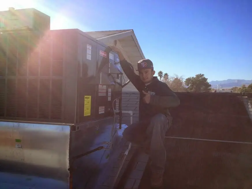 HVAC technician performing HVAC Inspection on a rooftop unit in Lower Gwynedd